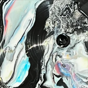 Close-up of marbled, swirled plastic in black, white, and iridescent tones