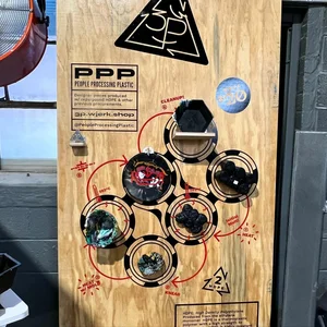 Close-up of the station's signage board, explaining the process with a circular diagram and the project's Instagram handle